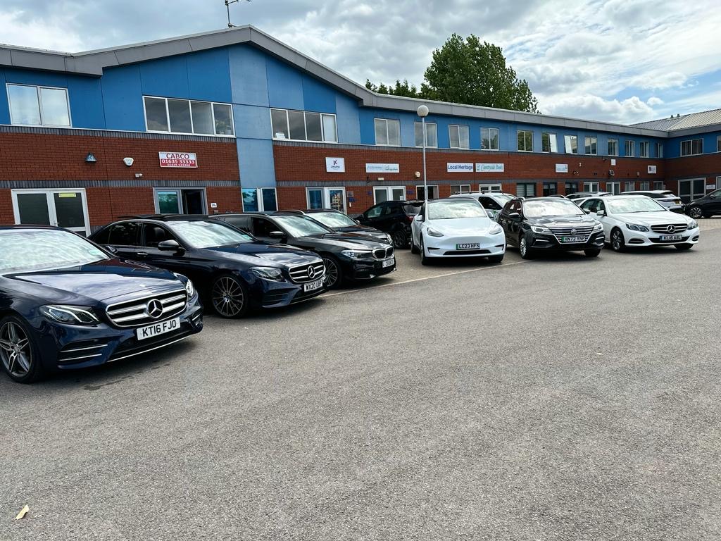 A Day in Newbury: Exploring the Town with CabCo 1 CabCo’s premium fleet of executive vehicles parked outside their Newbury headquarters – ready to take you on a comfortable tour of the town.
